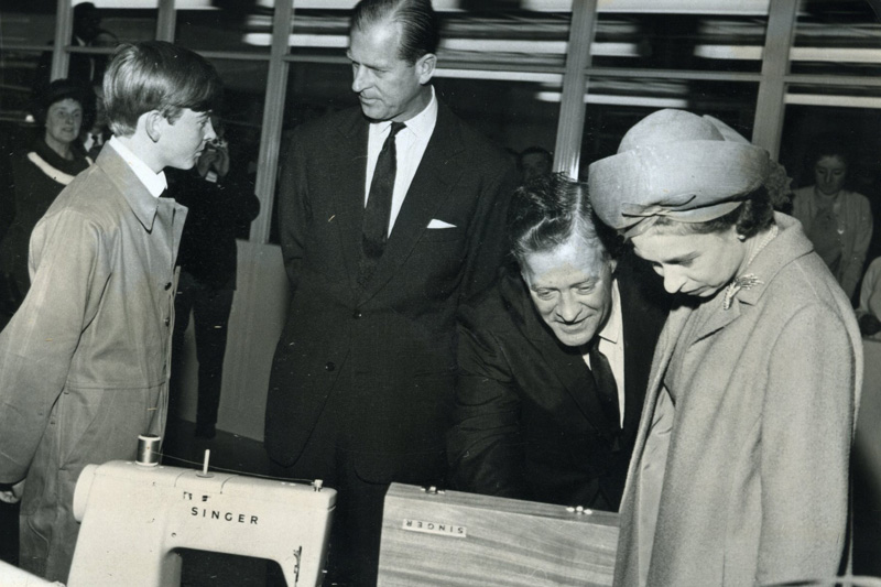 image of Queen Elizabeth II receiving a sewing machine