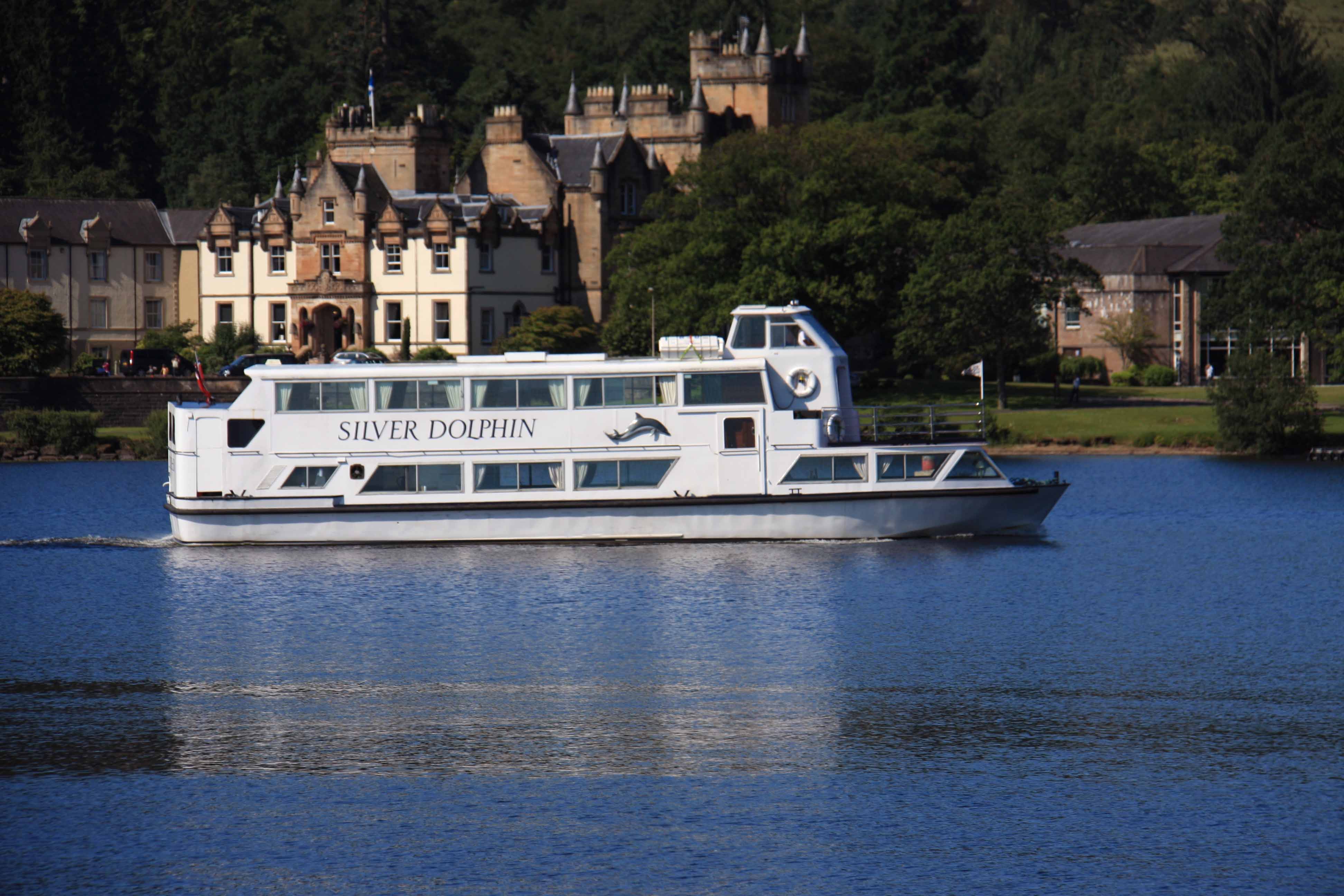 Sweeney's Cruises - Sliver Dolphin cruiser sailing past Cameron House