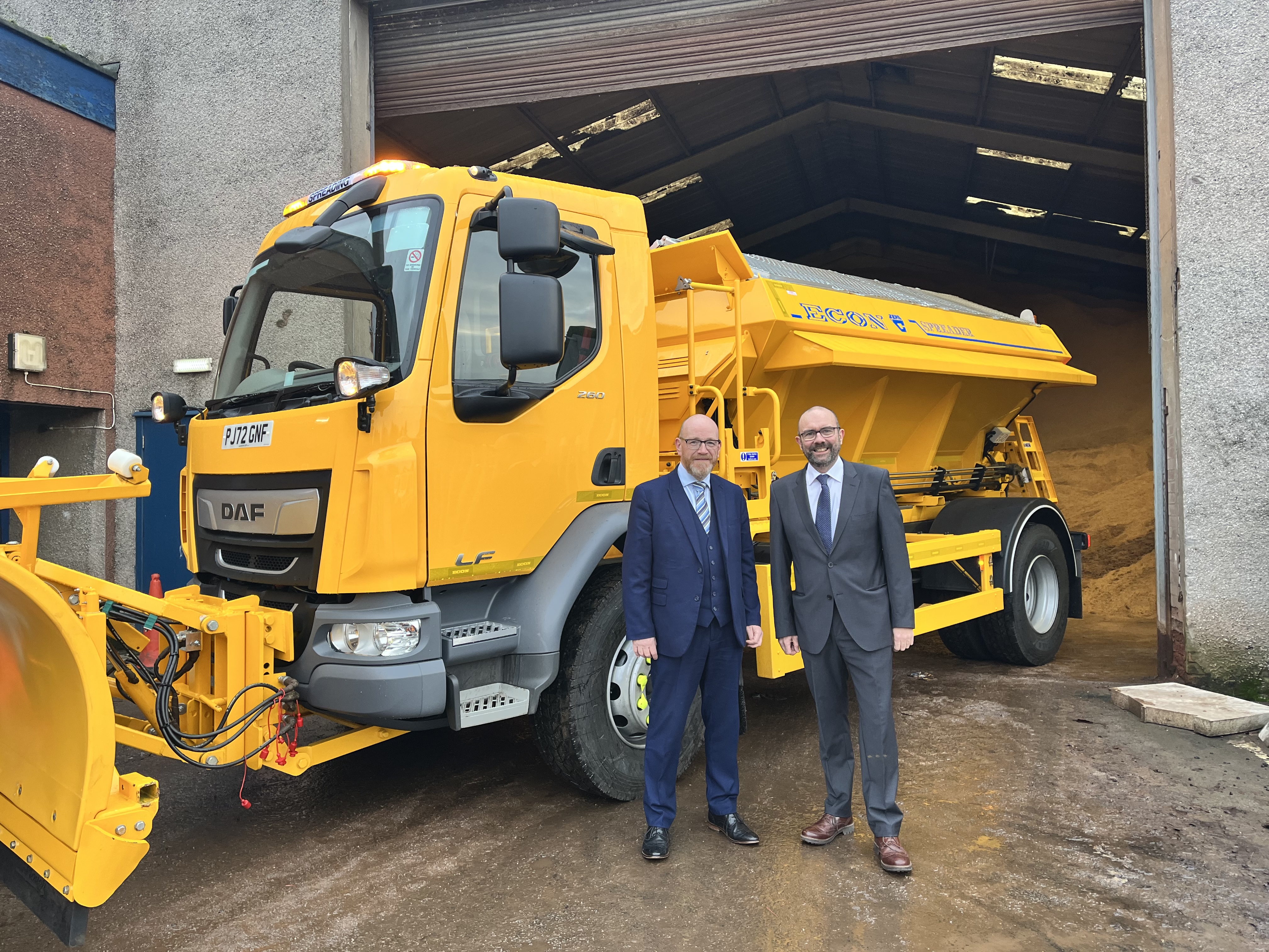 Councillor O'Neill and Councillor McBride standing beside Gritter