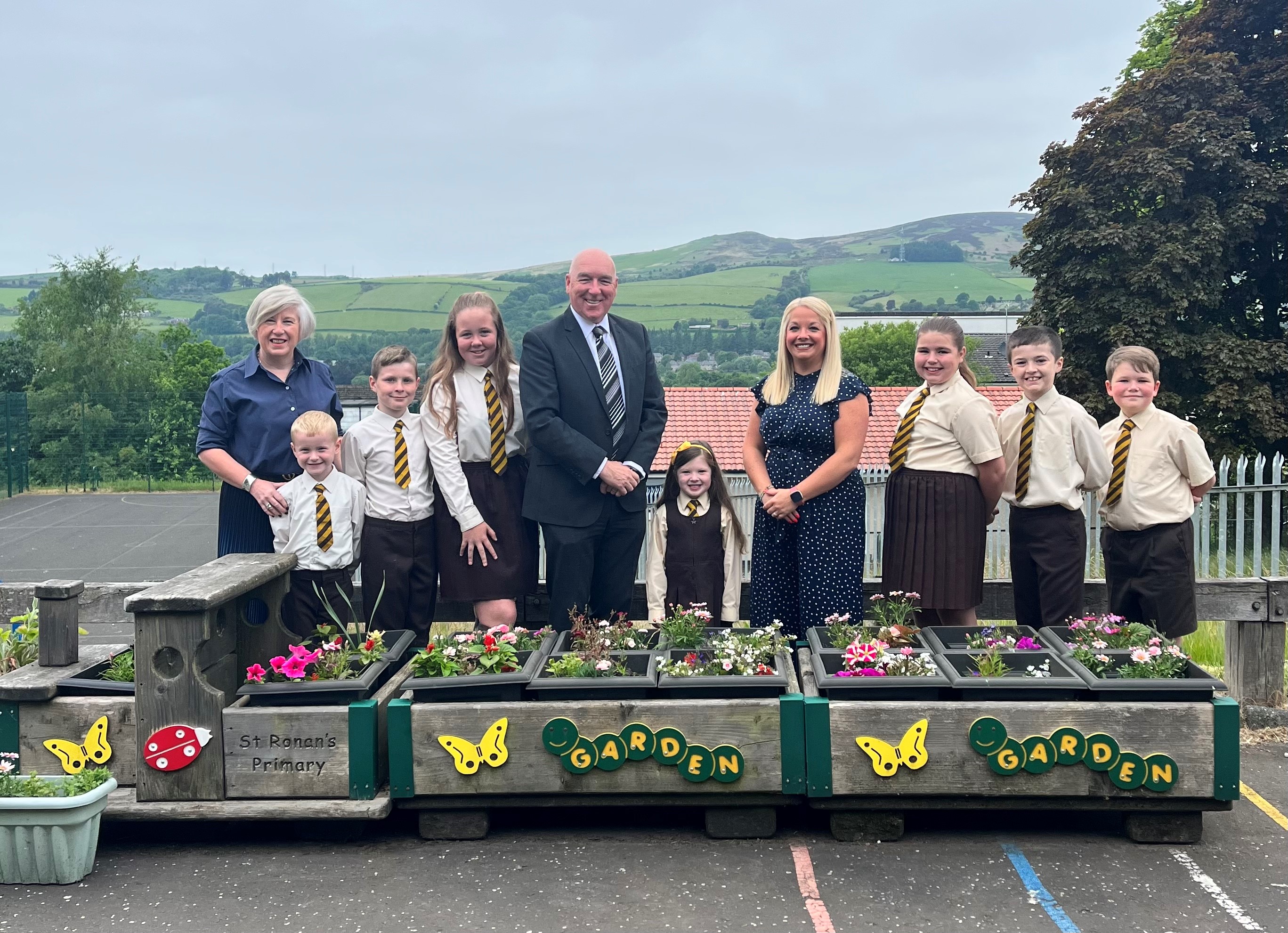 Councillors, Header Teacher and pupils from St Ronan’s Primary school standing in the playground